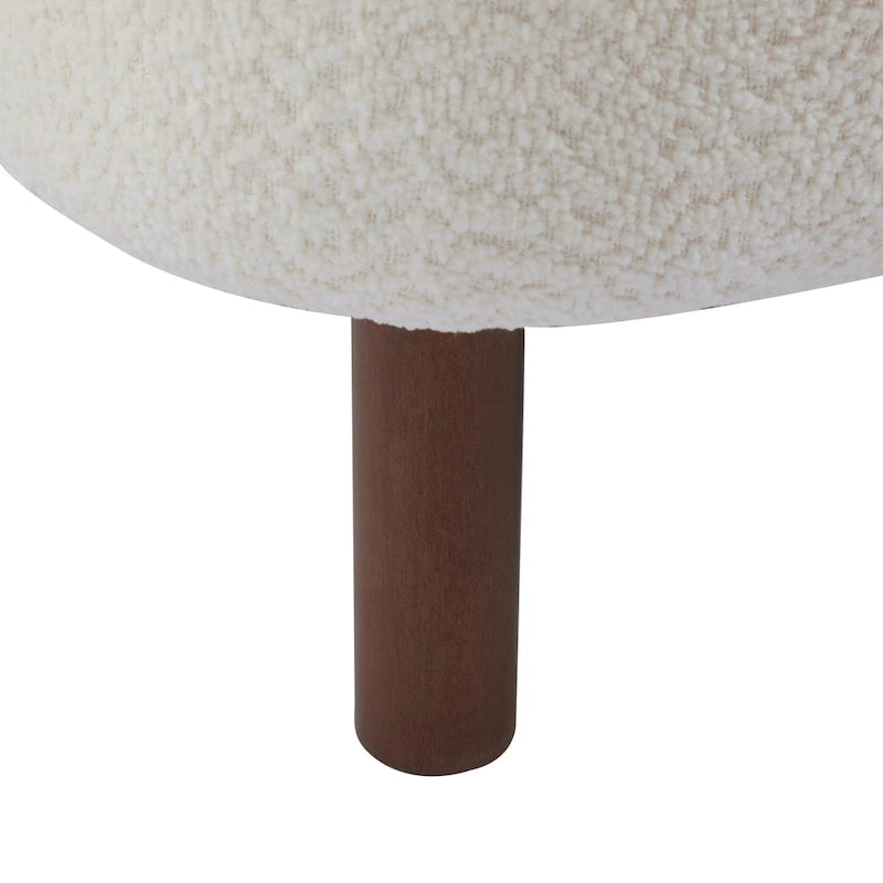 Moderne beklede armloze accentstoel met zachte zitting en frame van massief hout